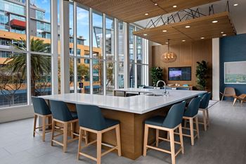 A modern dining room with a long table and chairs.